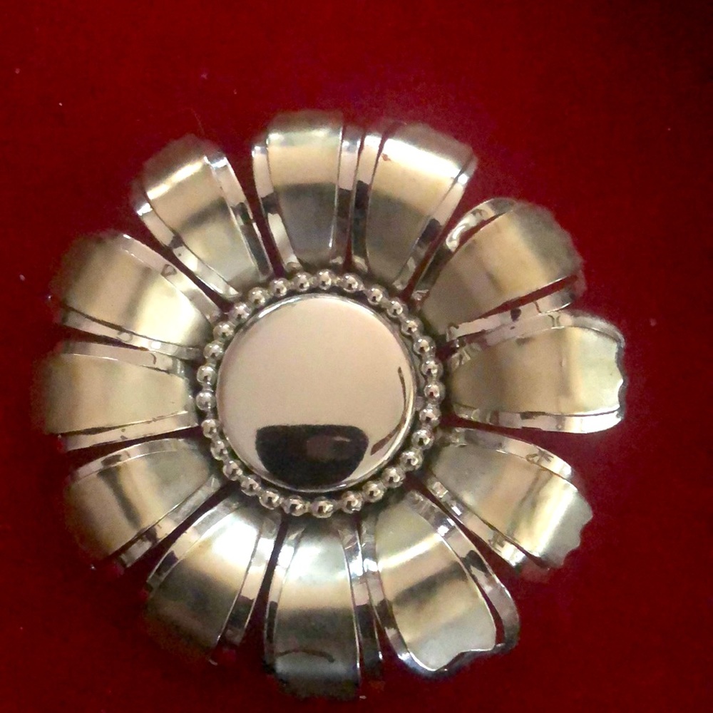 Large silver tone metal flower pin.
